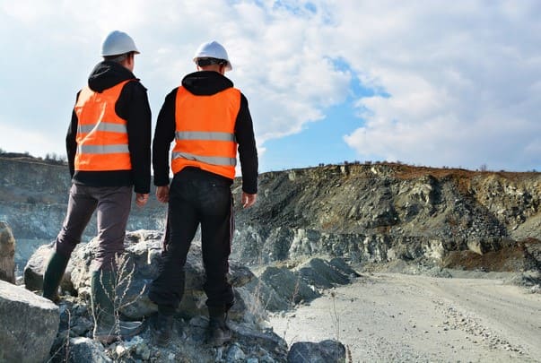 stock-photo-two-workers-and-quarry-in-background (1)